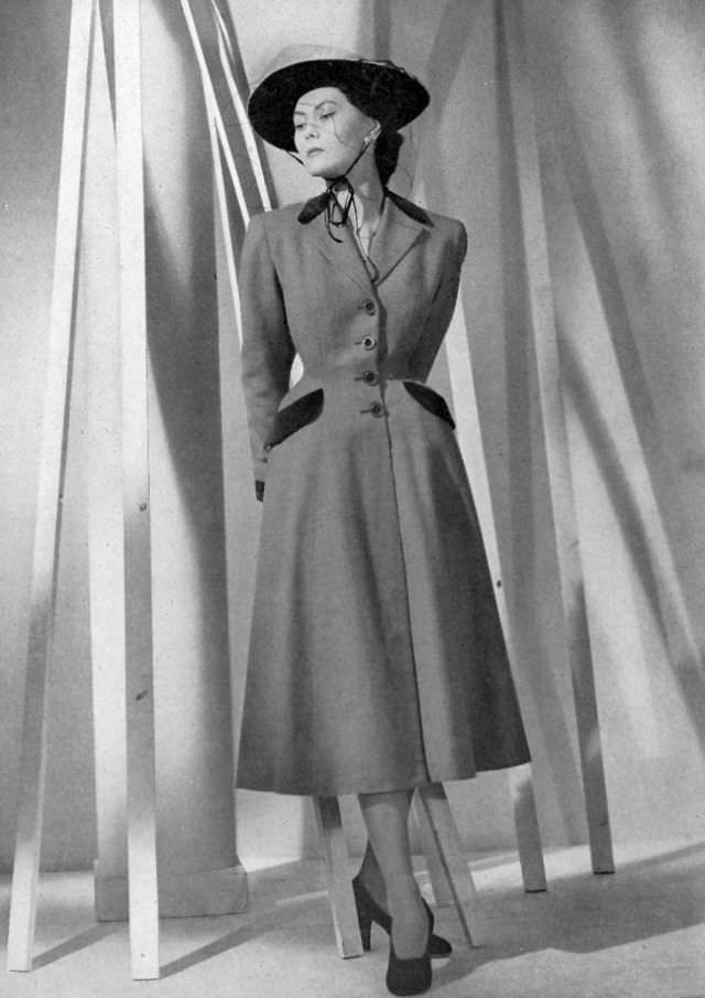 Alla in gray wool redingote with velvet lapels and pockets, by Vera Boréa, 1948