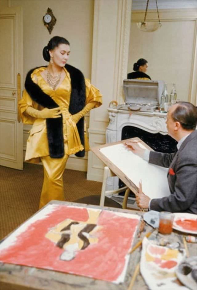 Alla, decked out in Dior’s evening finery called 'Artamène' is being sketched by Carl Erickson, best known as Eric, for Vogue, 1954