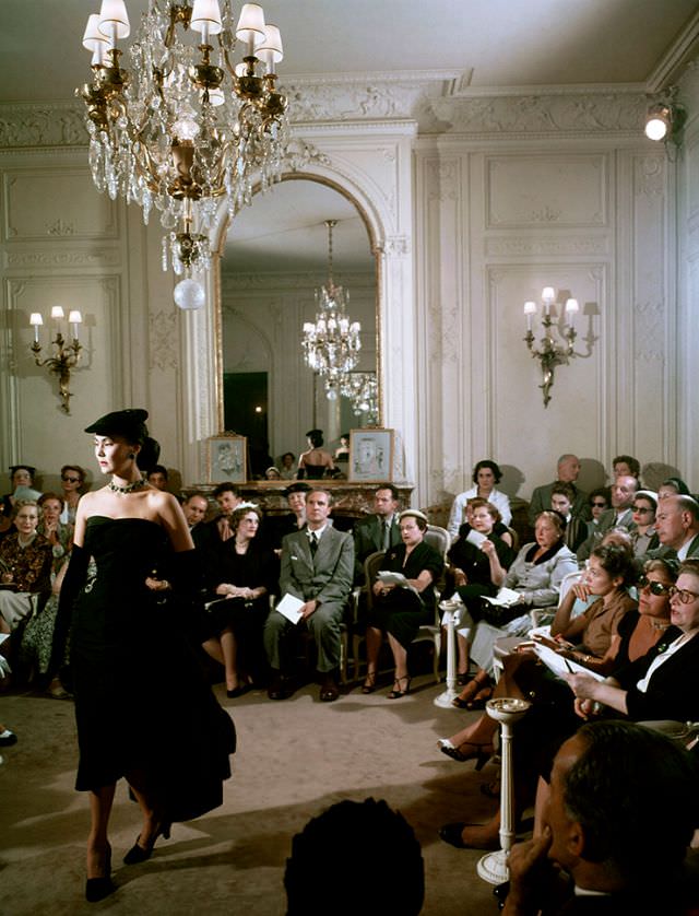 Alla models one of Christian Dior's cocktail dresses in his salon, Paris, circa 1950s
