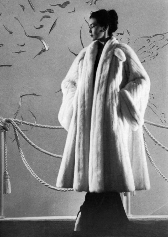 Alla is wearing a coat designed by Dior in Emba mink, the first perfectly white variety of mink, 1948