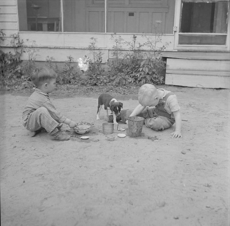 Two boys playing with a puppy