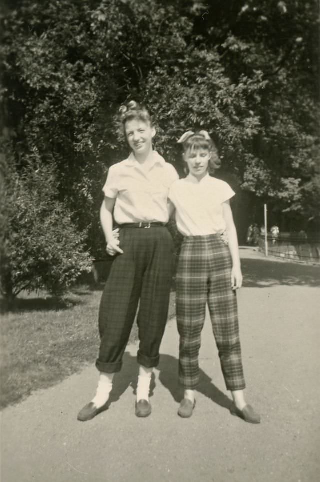 Two girls pose in plaid slacks