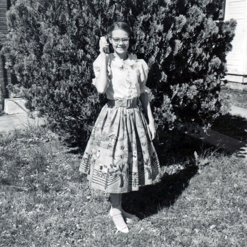 Girl appearing to be using a transistor radio