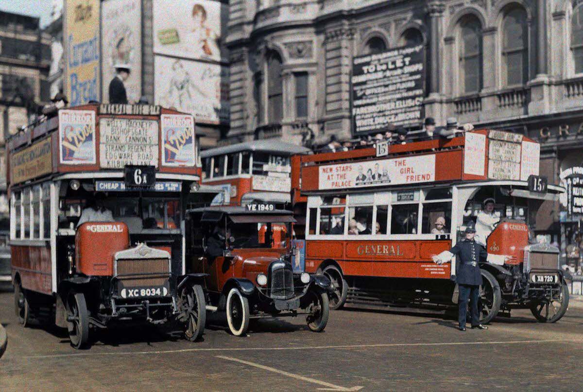 A policeman directs buses in the intersection of Trafalgar Square, London.