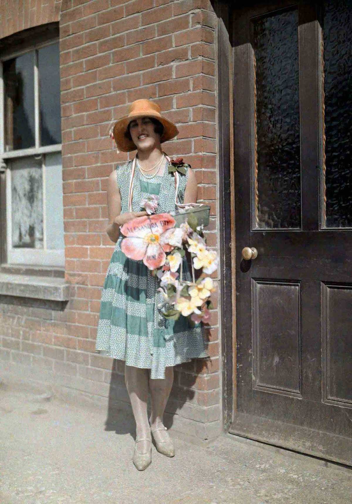 A young girl sells artificial flowers for charity on Alexandra Day, in Kent.