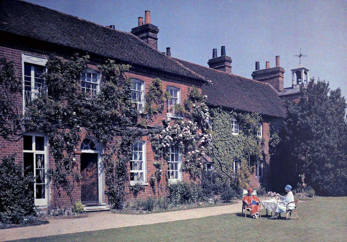 Women have tea in front of the Clock House, originally a hospice, in Buckinghamshire.