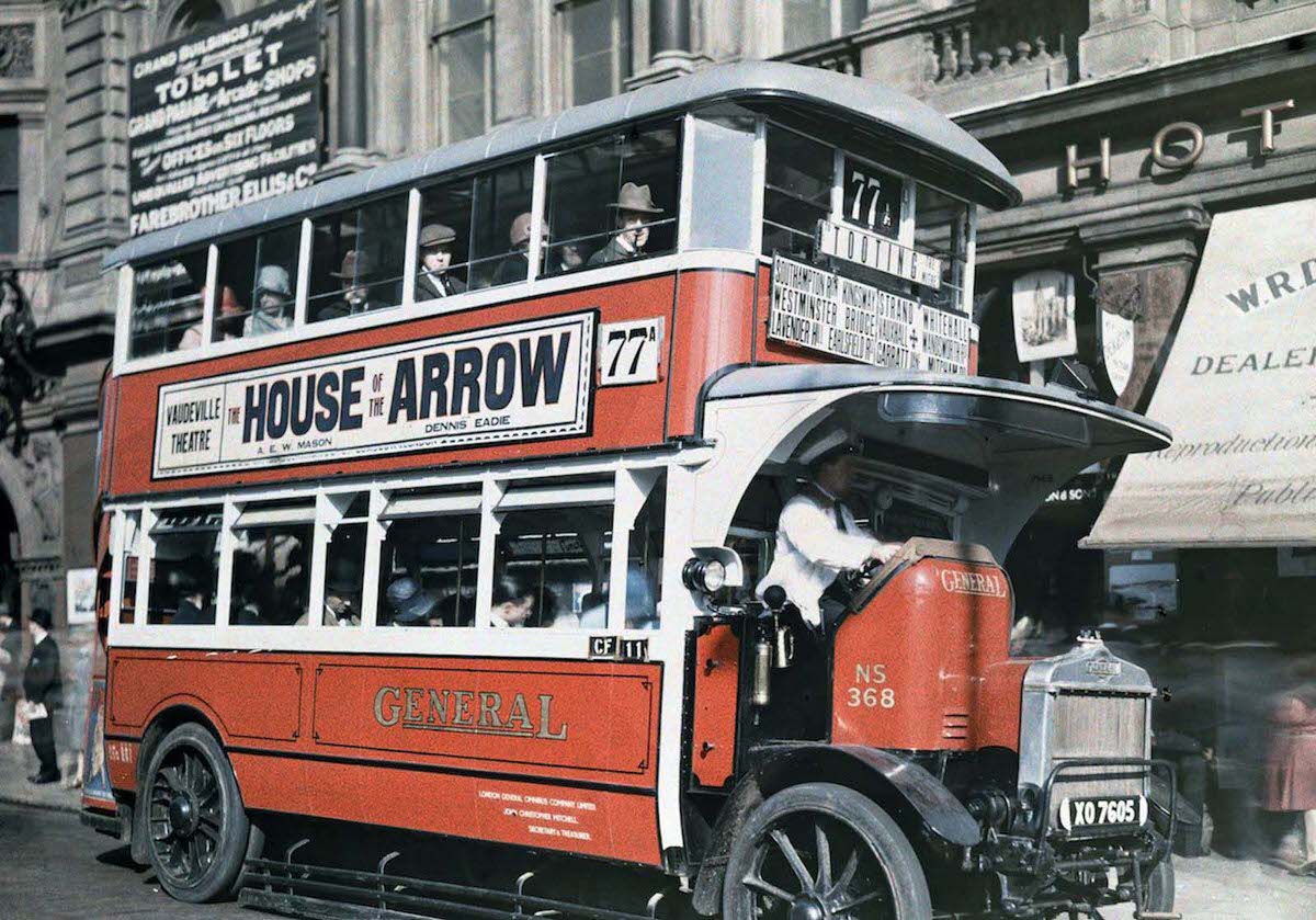 A London double-decker bus stops to allow people aboard.