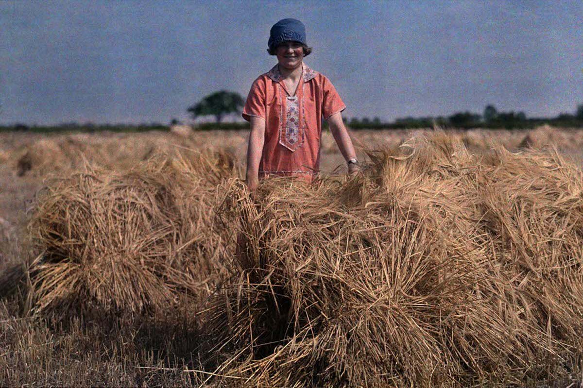 A girl stands in an unidentified field in Lincolnshire in 1929 holding barley.