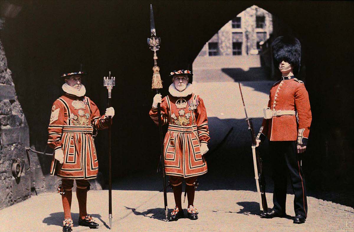 The Chief Warder, a Coldstream Guardsmen, and a Yeoman Warder pose at the Tower of London.