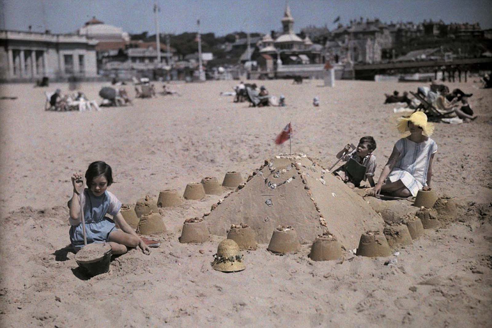 A family builds a sandcastle at the seaside resort of Sandbourne, near Bournemouth in Dorset.