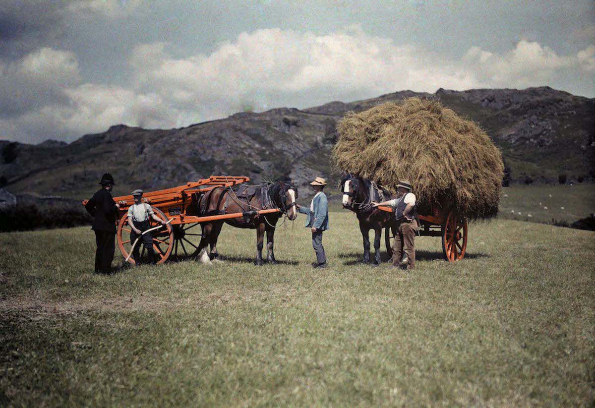 A police constable passes the day with farmers gathering hay, in Lancashire.