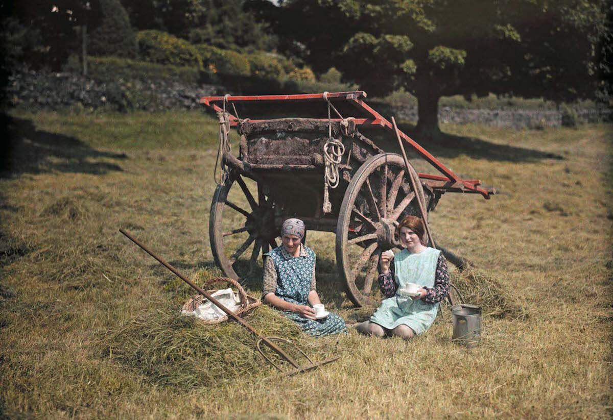 Two women rest for lunch in a Lancashire hayfield.