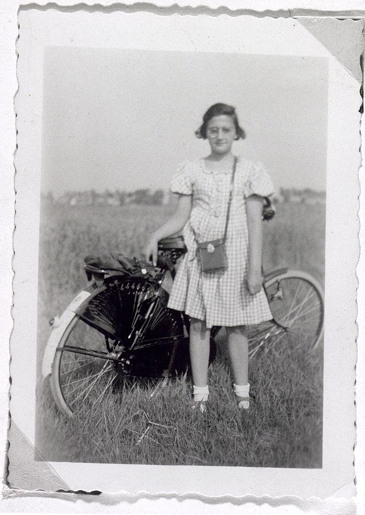 Anne Frank's sister Margot standing next to her bicycle in Amsterdam, 1938.