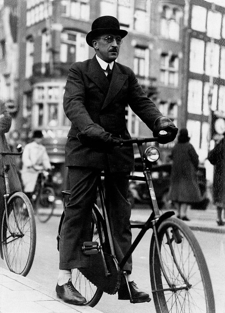 Cyclist with special hand warmers on a bike in the city Vintage property of ullstein bild in Amsterdam, 1930s.
