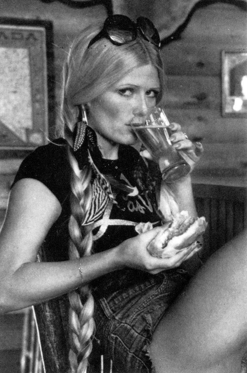 Debra Jo Fondren enjoying her burger and beer, 1970s.