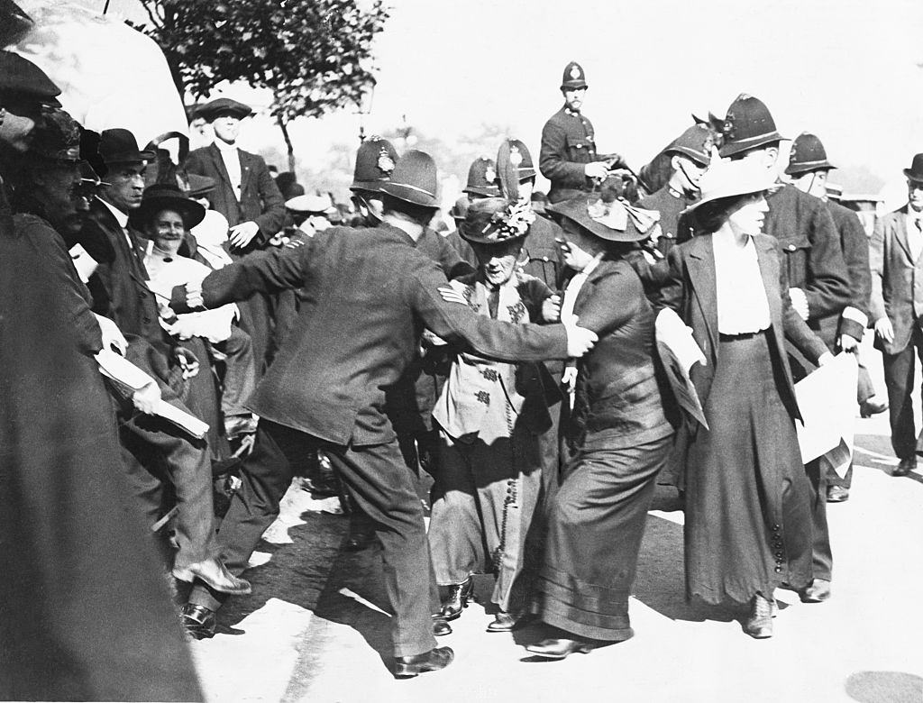 Police prevent suffragist Emmeline Pankhurst and her two daughters (left to right) Chistabel and Sylvia from entering Buckingham Palace to present a petition to the King.