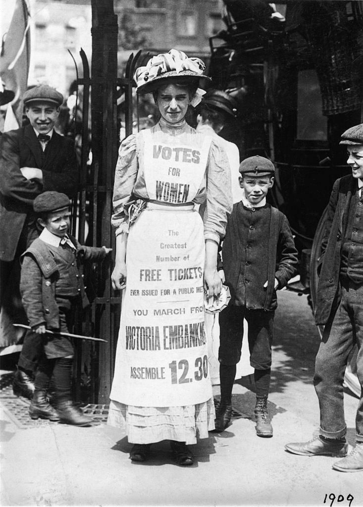 Suffragette advertising a march supporting votes for women, Strand, London, 1909.