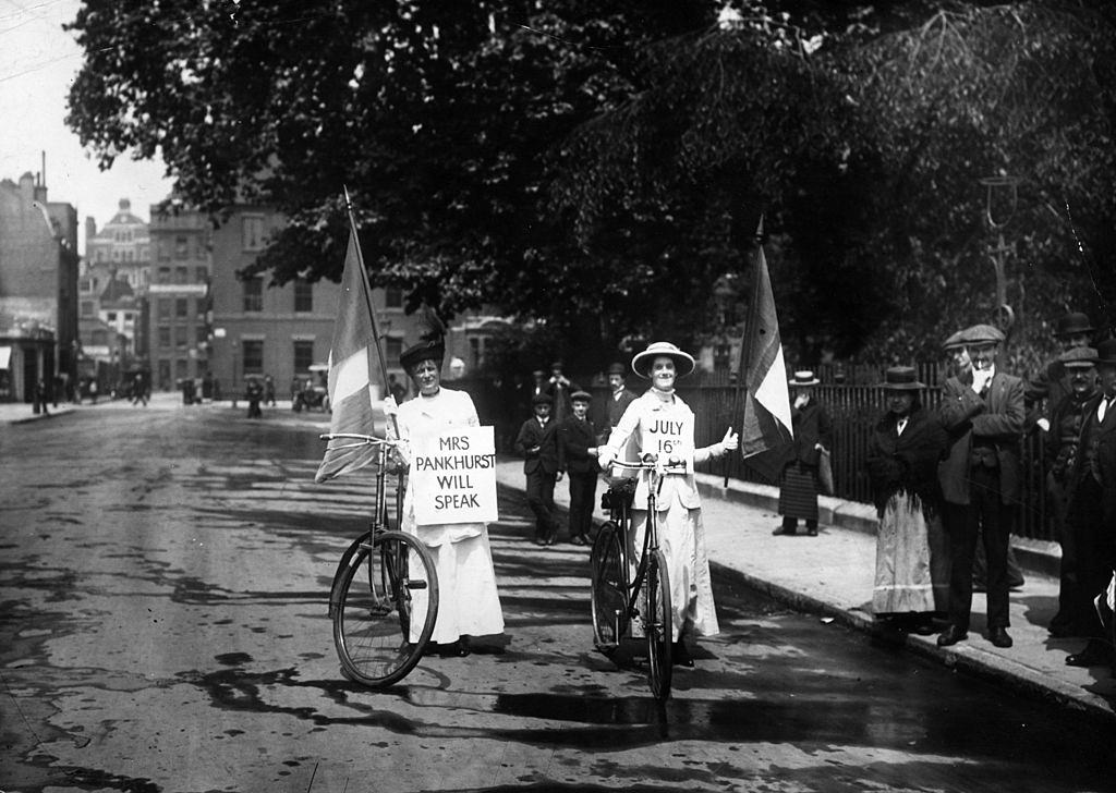 Two suffragettes advertising a meeting at which Emmeline Pankhurst will speak, 1914.