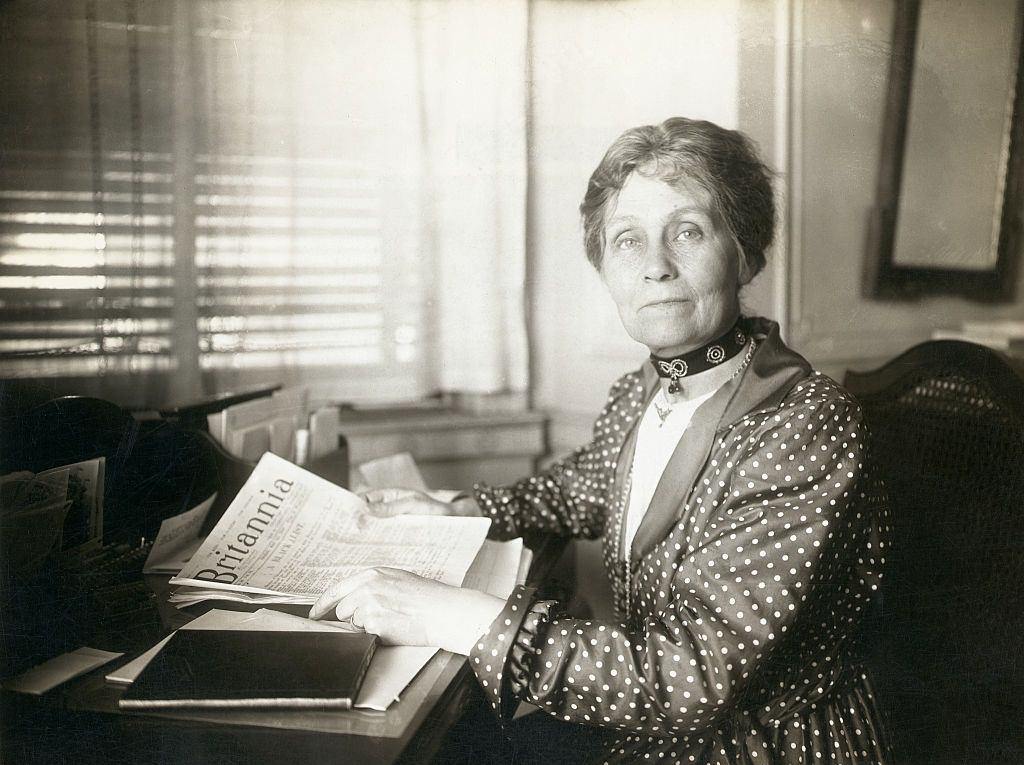 Emmeline Pankhurst pauses in her reading for a portrait.