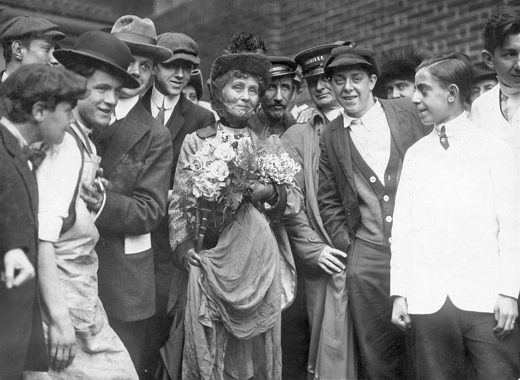 Emmeline Pankhurst standing with a group of men.