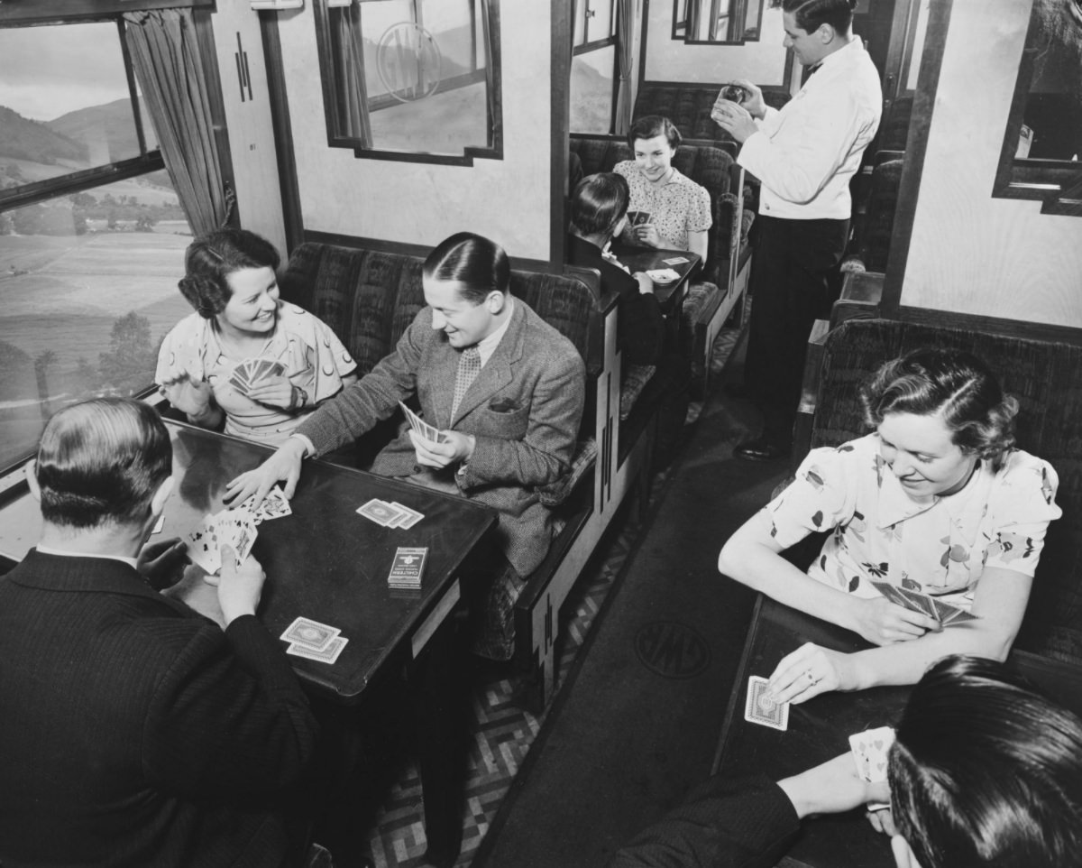 Passengers playing cards in a third class carriage, February 1938.