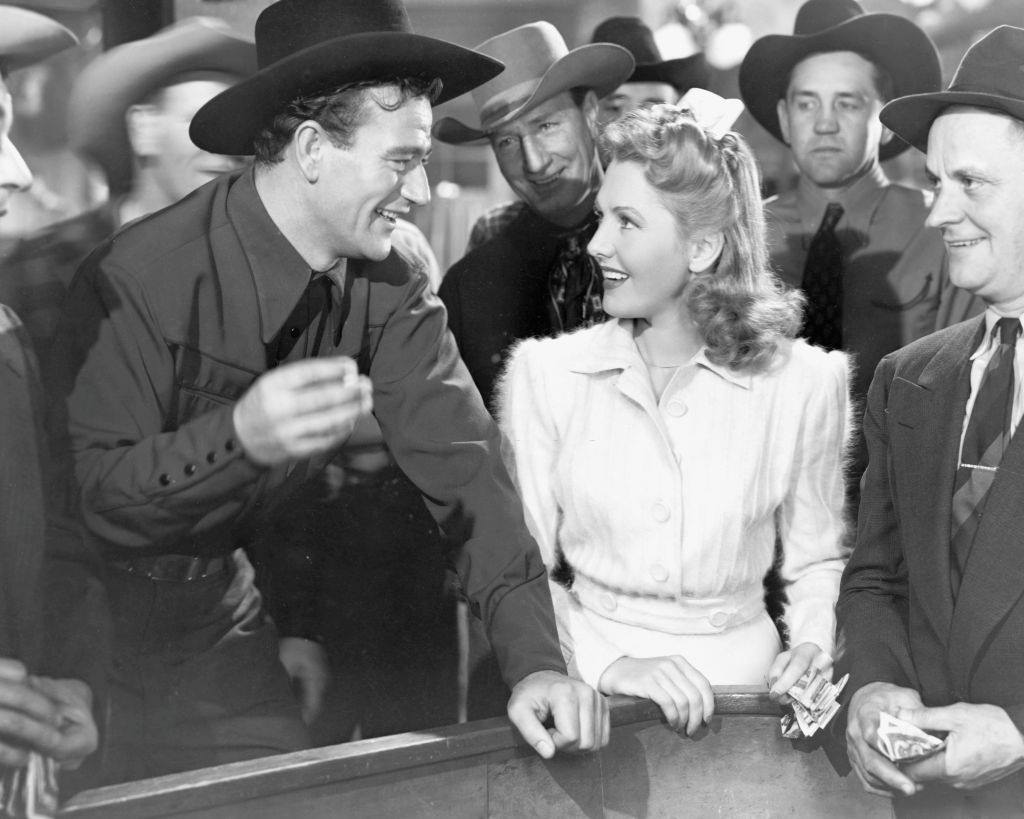 Jean Arthur as Molly J. Truesdale and John Wayne as Duke Hudkins in the romantic comedy 'A Lady Takes a Chance', 1943.