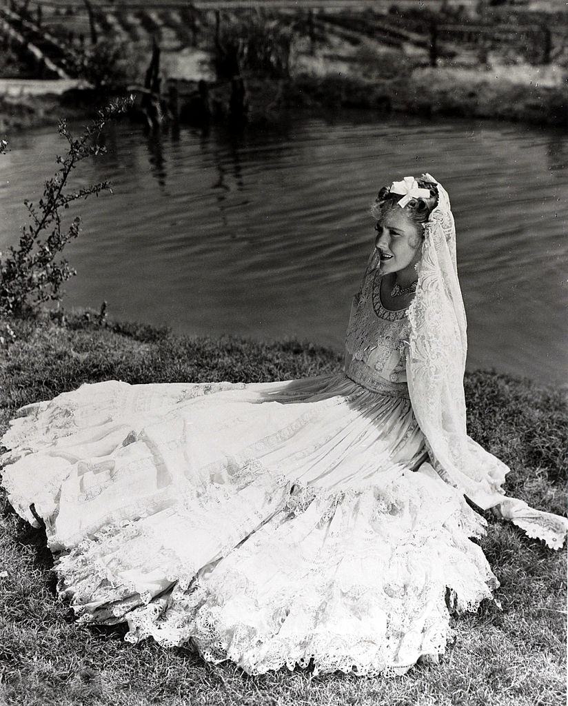 Jean Arthur wearing a flowing dress and veil, 1930.