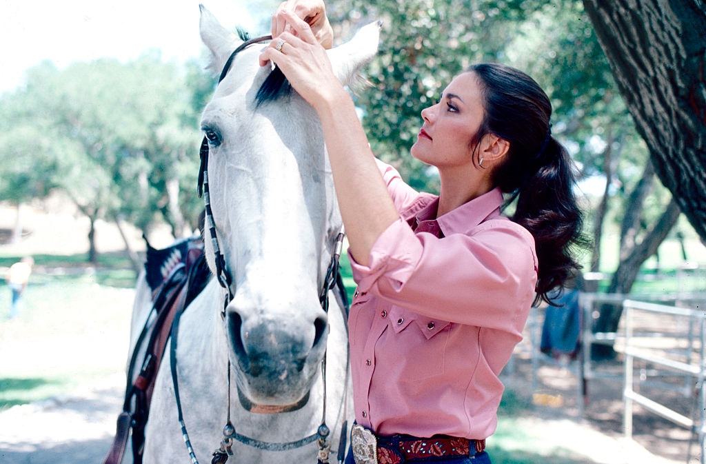 Lynda Carter with a horse, 1981.