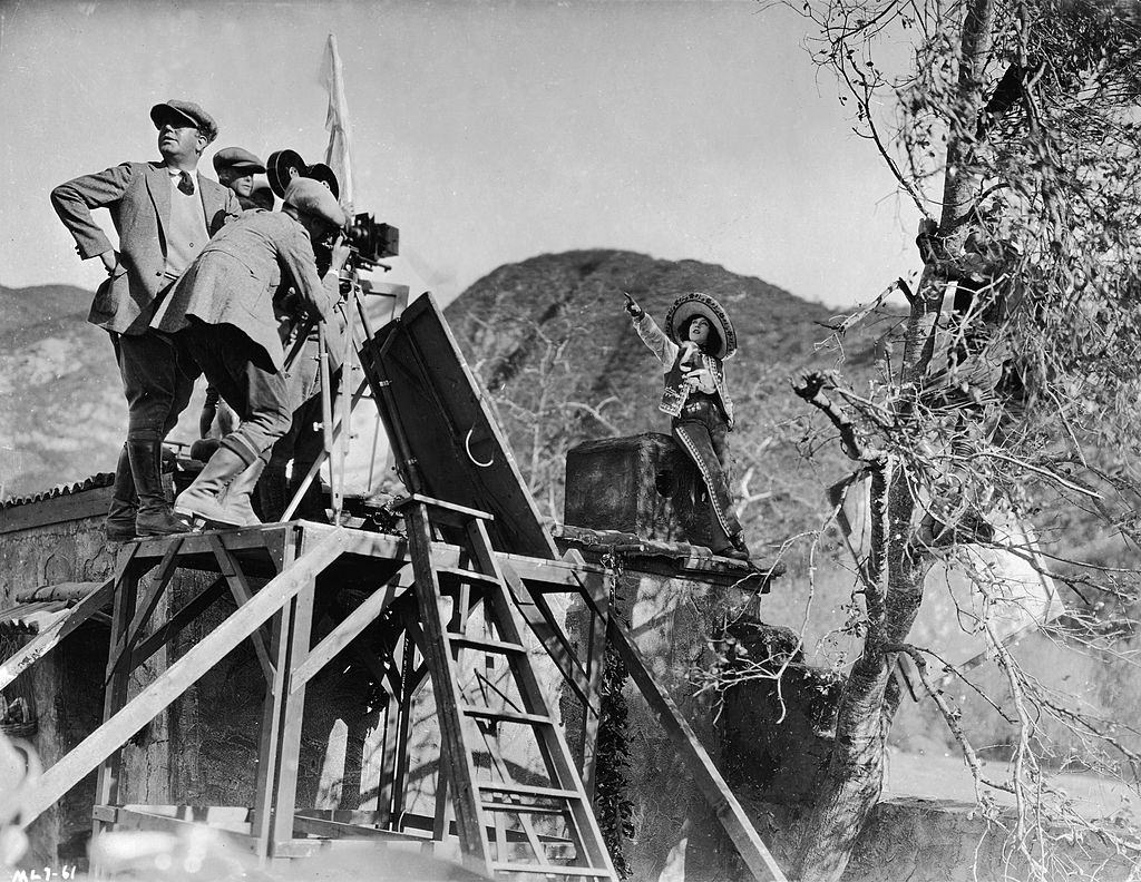 Mae Murray with camera crew shoot a scene on location for the film, 'Mademoiselle Midnight,' 1924.