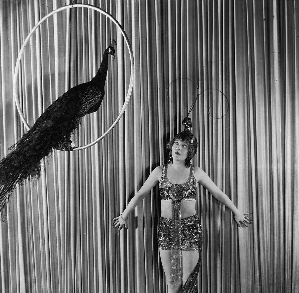 Mae Murray in peacock costume and headdress as Cleo of Paris in 'Peacock Alley', 1922.