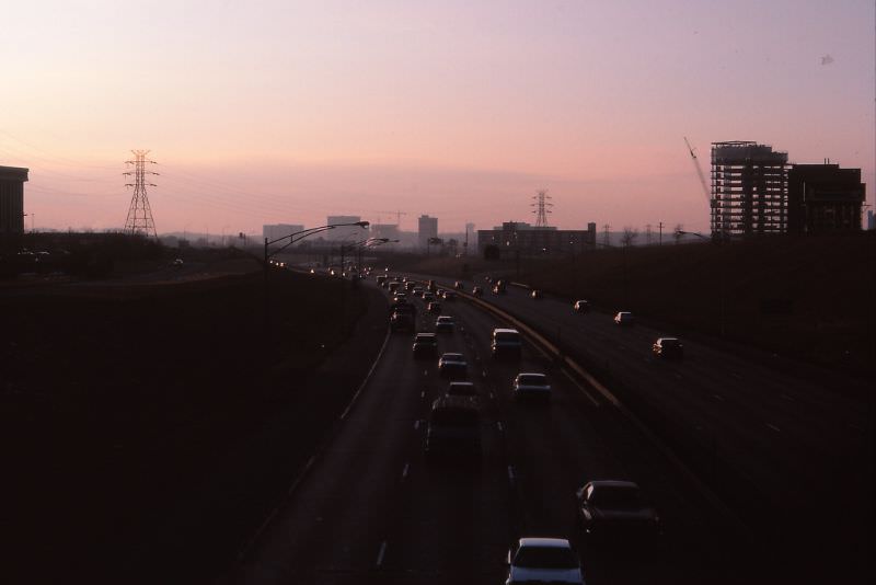 I-494 twilight, the Bloomington Strip. Minnesota Center UC at right, crane for 8400 Normandale visible in center background, fall 1986