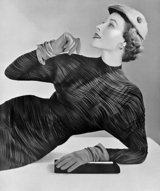 Myrtle Crawford in black and brown print dress by Carven, cap by Claude St. Cyr, 1953