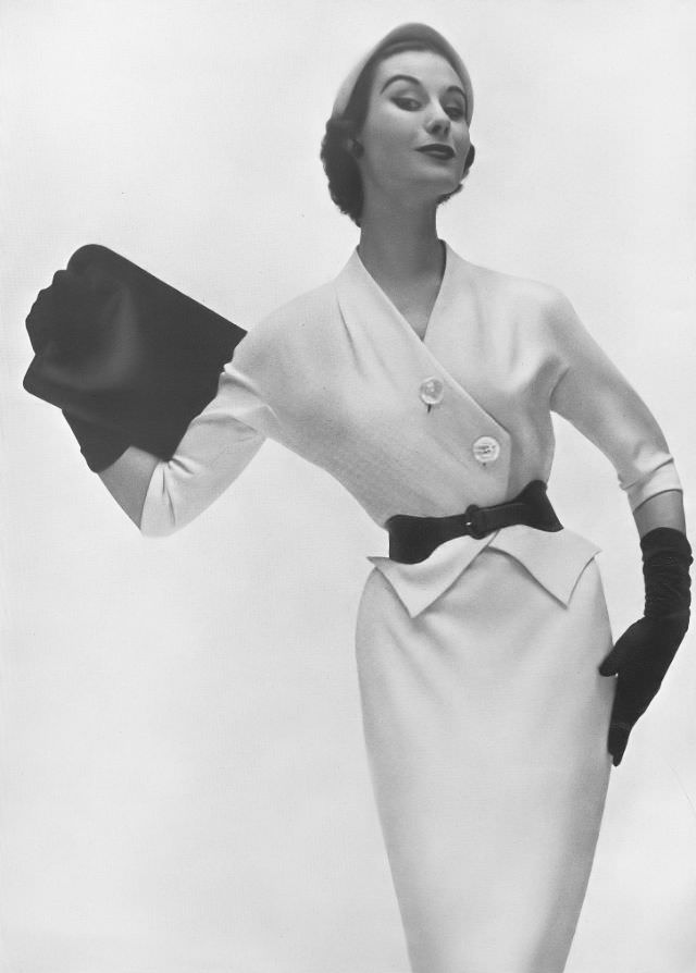 Myrtle Crawford in ivory-white woolen day dress contrasted with black belt by Matita, Harper's Bazaar UK, February 1953