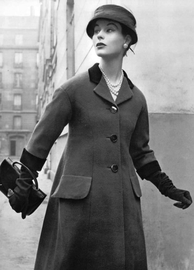 Myrtle Crawford in purple wool redingote with burgundy velvet collar and cuffs by Jaques Fath, 1953