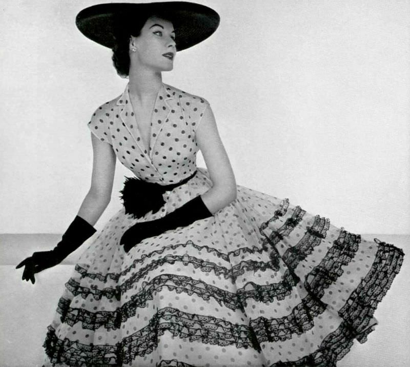 Myrtle Crawford in white with black polka-dots mousseline dress, 1954.