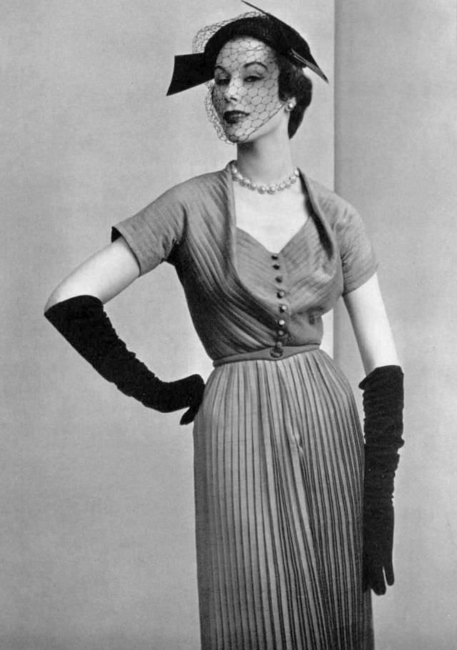 Myrtle Crawford in silk afternoon dress delicately pleated throughout with finely draped neckline by Manguin, 1952