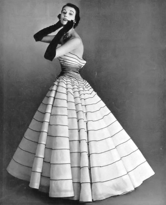 Myrtle Crawford in white tulle evening gown applied entirely with thin bands of black velvet, by Manguin, 1952