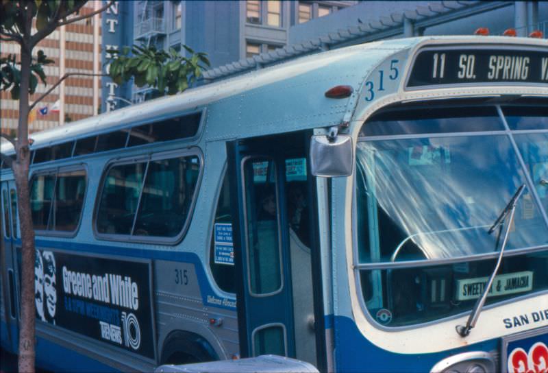 A 1968 GMC bus operating on Route 11 picks up passengers on Broadway at 4th Avenue (Horton Plaza)