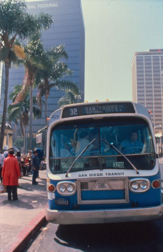 A 1972 GMC bus operating on Route 32 picks up passengers on Broadway at 4th Avenue (Horton Plaza)