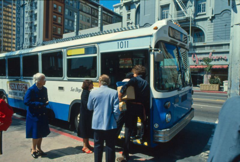 A 1978 MAN articulated bus operating on Route 7 picks up passengers on Broadway at 4th Avenue (Horton Plaza)