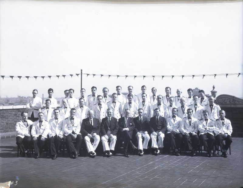 Group portrait of Chase Hotel waiters, posed on the hotel's roof, May 1931