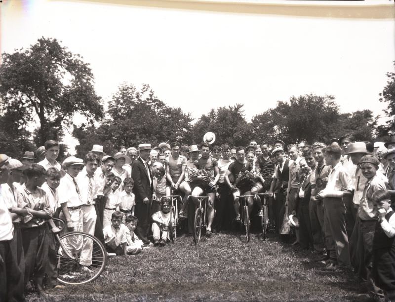 Winners holding flowers after a marathon bicycle race held in O’Fallon Park, June 1931