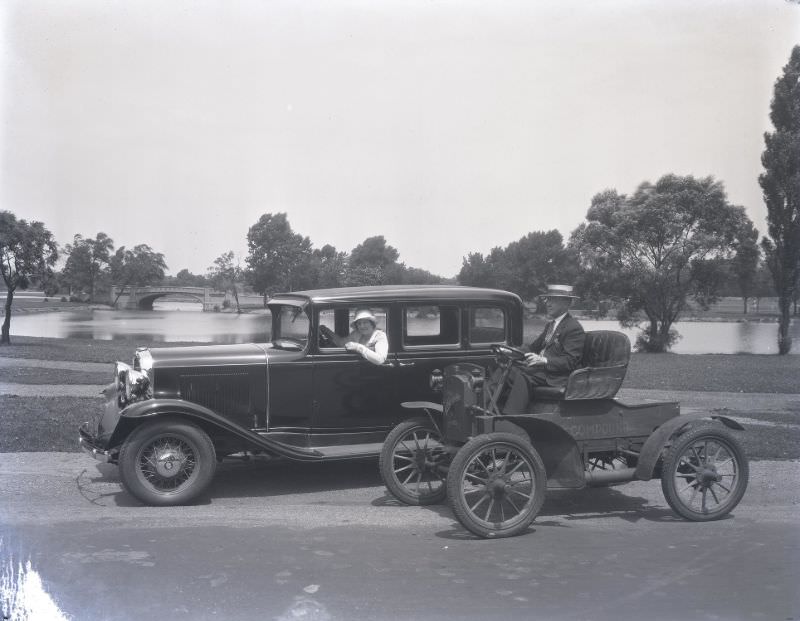 "Then and now” photo of two Oldsmobile cars. The vintage 1897 model Oldsmobile is parked next to a new 1931 Oldsmobile. June 1931