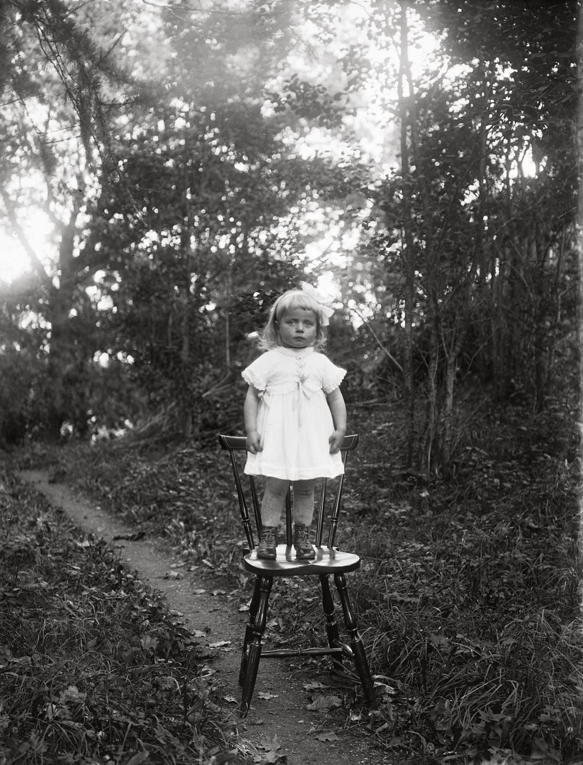 Ljung’s daughter standing by herself on a chair, Torstunaby, Torstuna parish, 1920