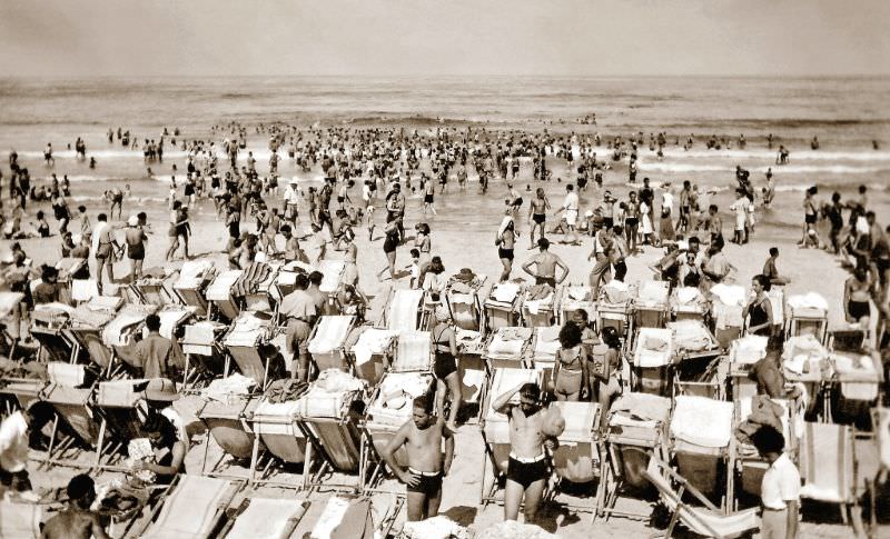 Allied troops and local Tel-avivians enjoying the sun, sand and surf on the crowded beach at Tel Aviv, Palestine (now Israel), July 1942