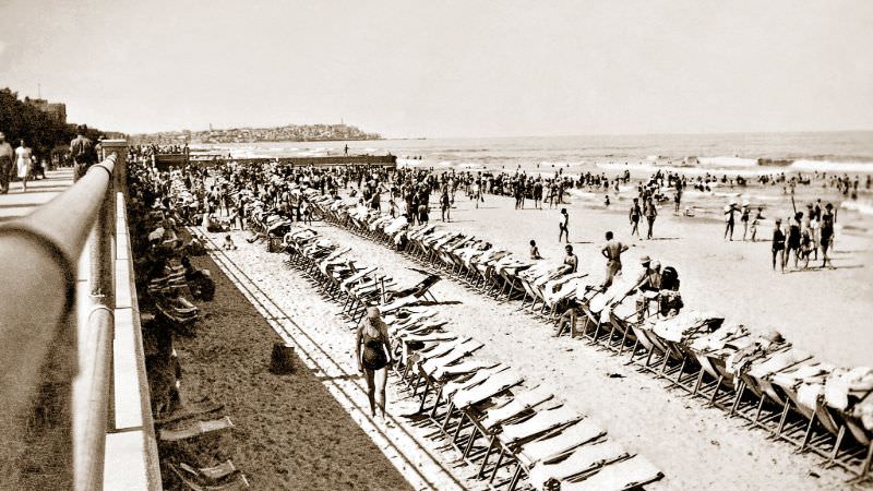 View south towards Old Jaffa as allied troops and crowds of local Telavivians enjoy a beautiful sunny day on the beach at Tel-Aviv, Palestine (now Israel), July 1942