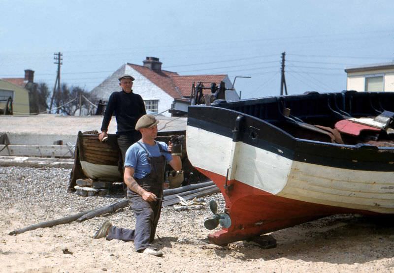 Man repairing boat at Kessingland, Suffolk