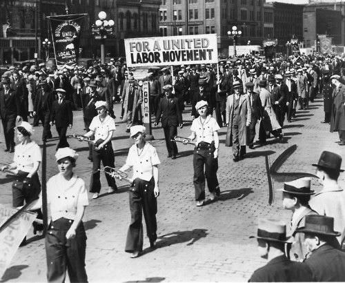 Workers marching through Minneapolis Loop in observance of May Day chanting, 1937