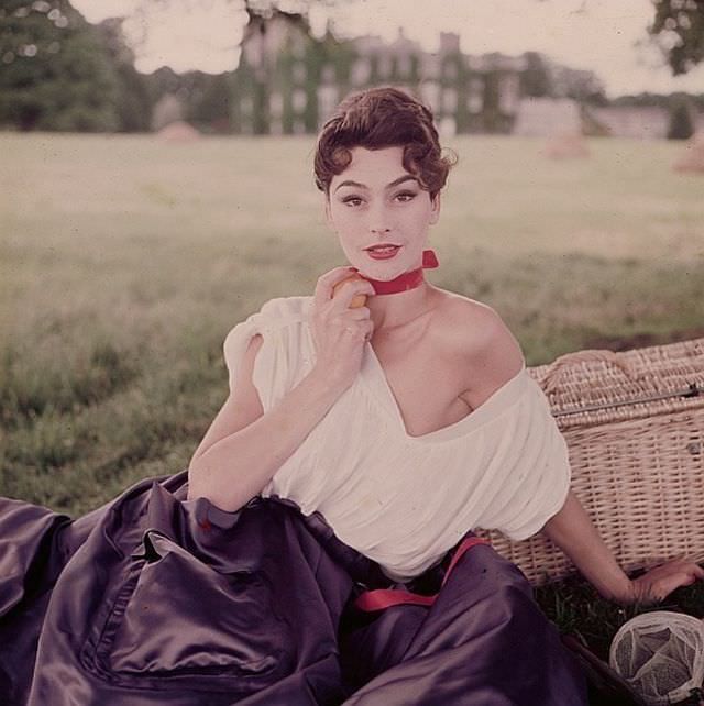 Anne Gunning in pleated cambric top and satin skirt for evening by Sybil Connolly, at Dunsany Castle in Ireland, LIFE, 1953