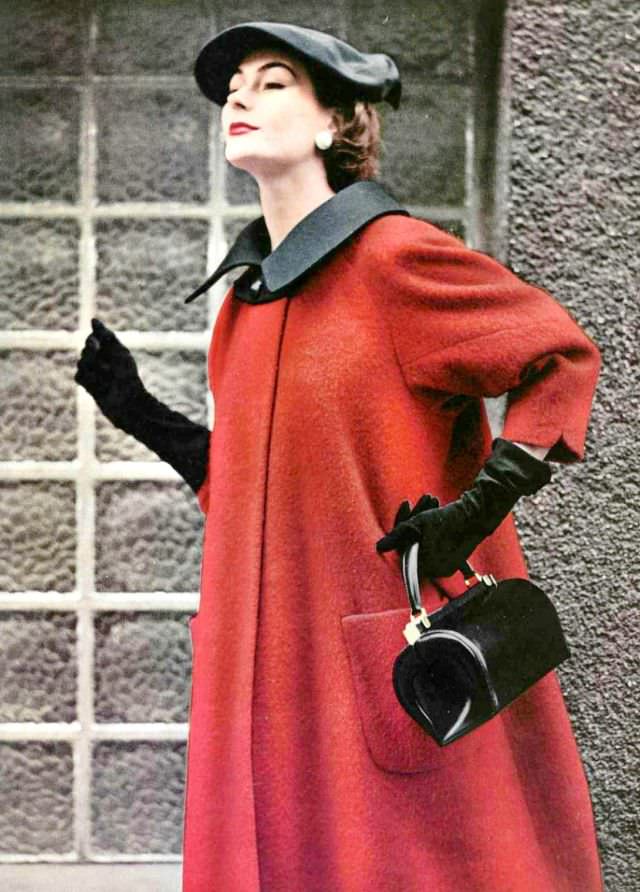 Anne Gunning in red wool coat with black collar, single button closure, black gros-grain beret, by Manguin, handbag by Roger Model, 1953